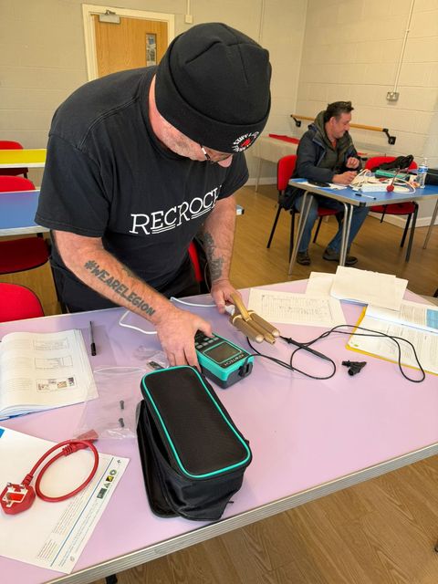 Learner using a PAT tester in class